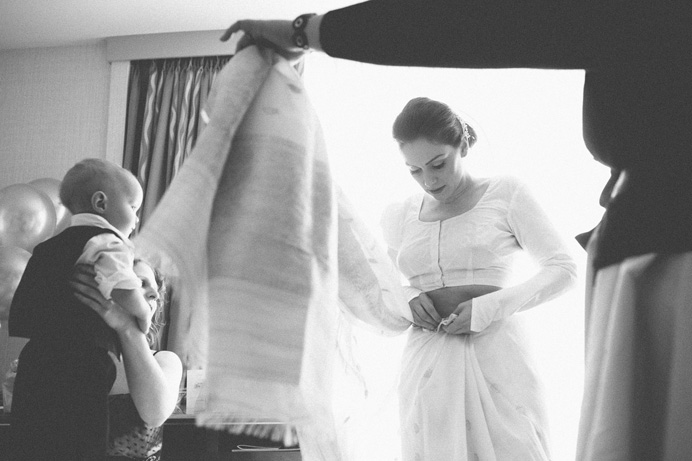 Bride putting on a sari before the wedding Tea House in Stanley Park Wedding on New Years Day | Linnie + Nico