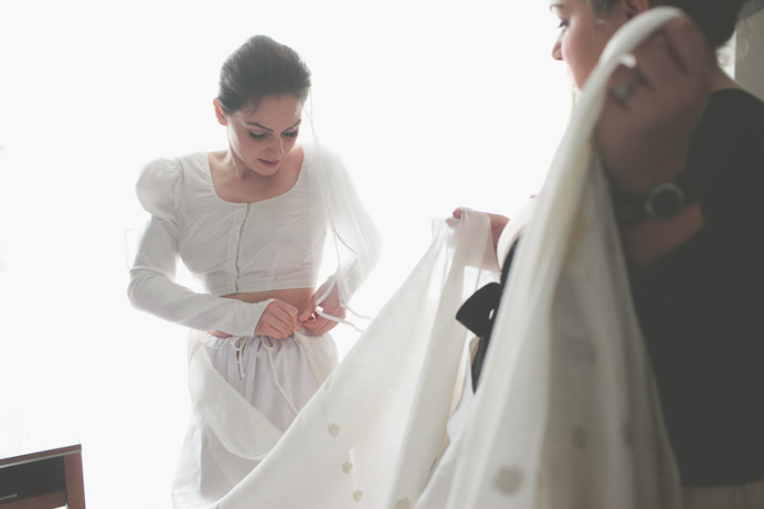 Bride putting on a sari before the wedding Tea House in Stanley Park Wedding on New Years Day | Linnie + Nico