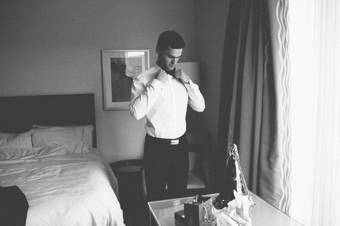 Groom getting ready at the Westin Bayshore Hotel Tea House in Stanley Park Wedding on New Years Day | Linnie + Nico