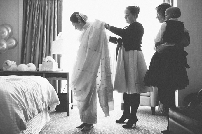 Bride putting on a sari before the wedding Tea House in Stanley Park Wedding on New Years Day | Linnie + Nico